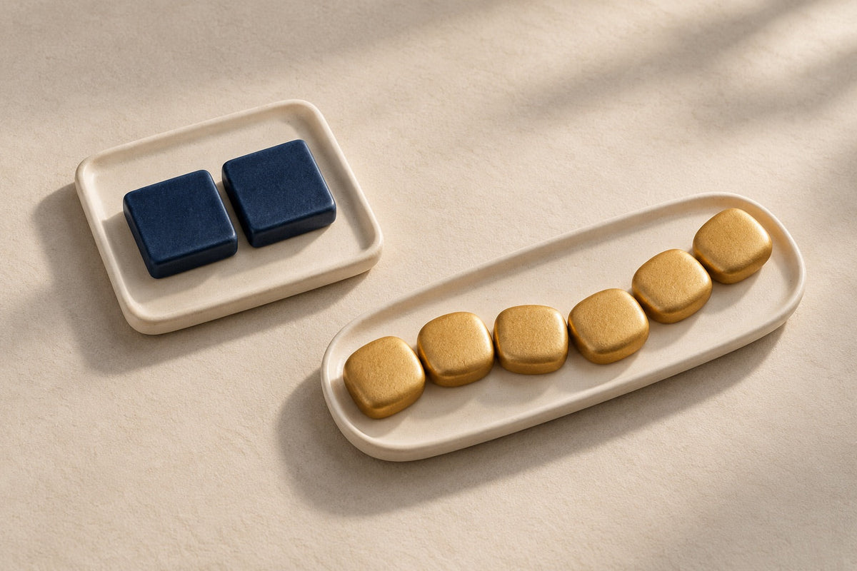 Two navy ceramic tiles and a separate chain of six gold tiles form an abstract classification comparison.