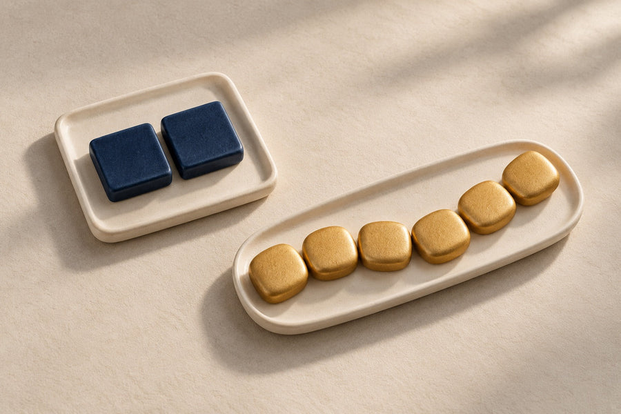 Two navy ceramic tiles and a separate chain of six gold tiles form an abstract classification comparison.