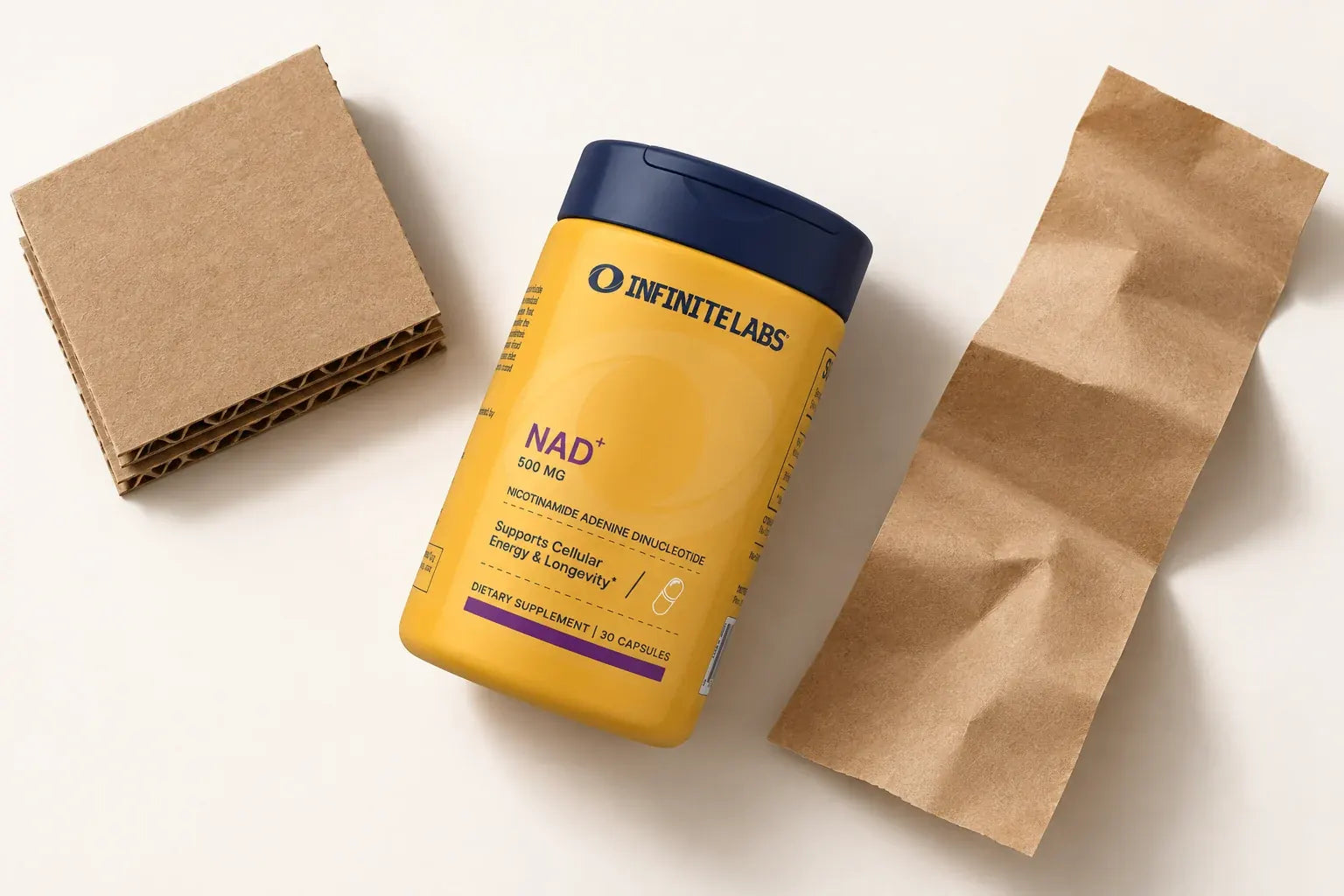 Overhead view of an InfiniteLabs NAD+ bottle beside corrugated cardboard and plain kraft paper.