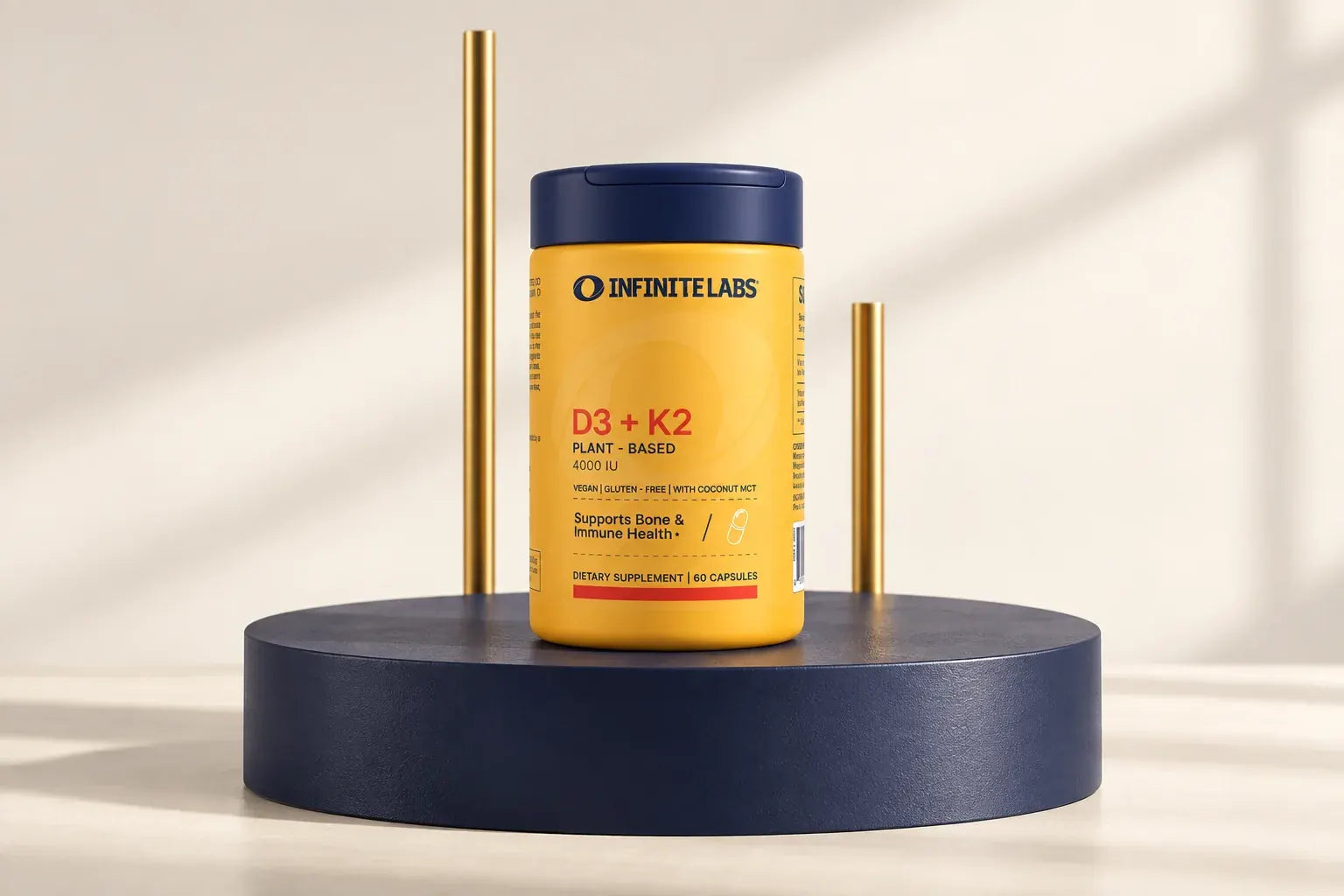 InfiniteLabs D3 + K2 bottle on a navy platform with two gold-toned rods.